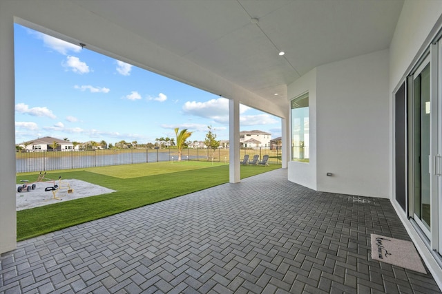 view of patio with a water view