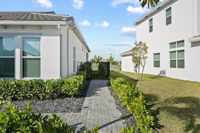 view of side of home featuring a lawn