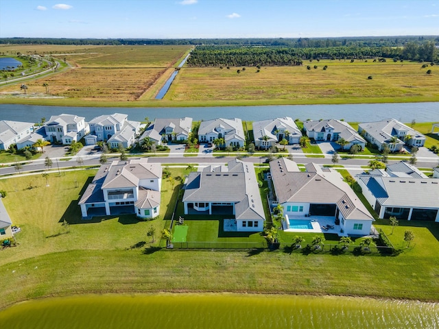 aerial view with a rural view and a water view