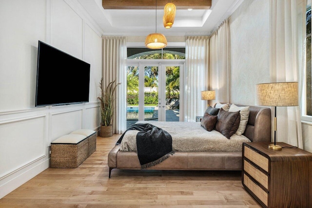 bedroom with french doors and light wood-type flooring