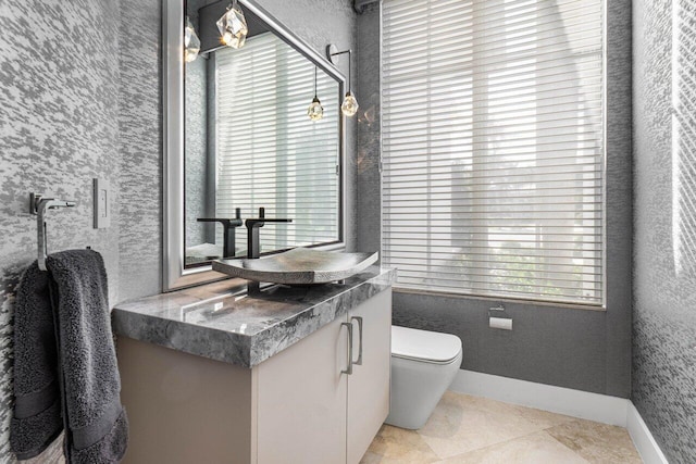 bathroom with tile patterned flooring, vanity, and toilet