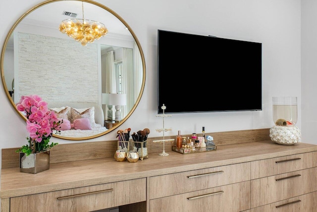 details featuring a notable chandelier and crown molding