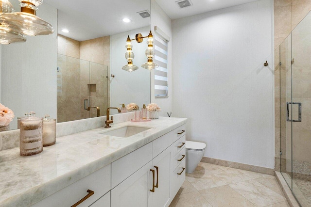 bathroom featuring vanity, toilet, and a shower with shower door