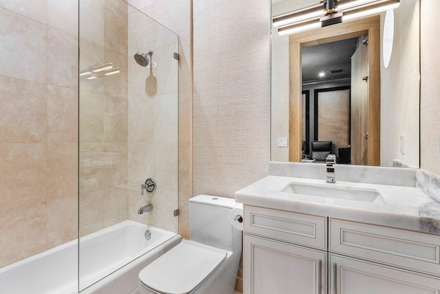 full bathroom featuring toilet, vanity, and tiled shower / bath