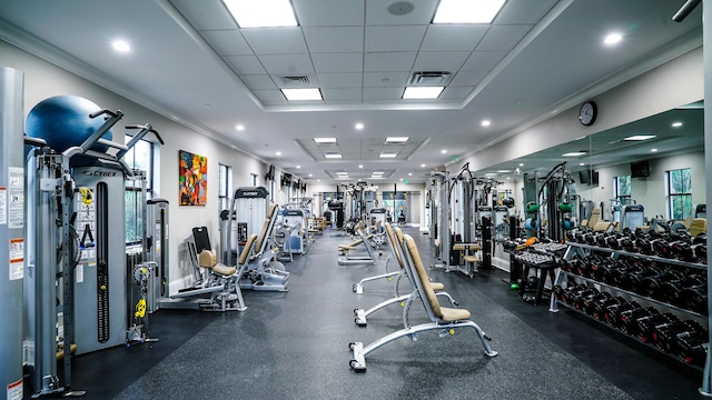 exercise room featuring a paneled ceiling and ornamental molding