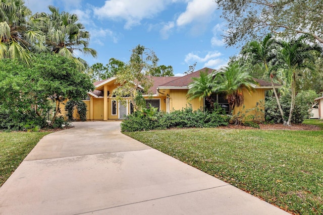 single story home featuring a front lawn