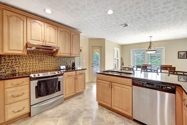 kitchen with sink, a textured ceiling, hanging light fixtures, and appliances with stainless steel finishes