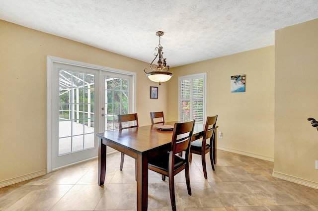 tiled dining space with a textured ceiling