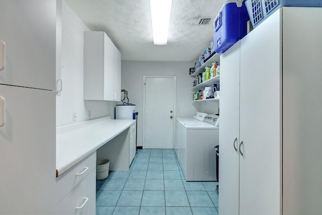 laundry area featuring electric water heater, a textured ceiling, light tile patterned flooring, water heater, and washer and clothes dryer