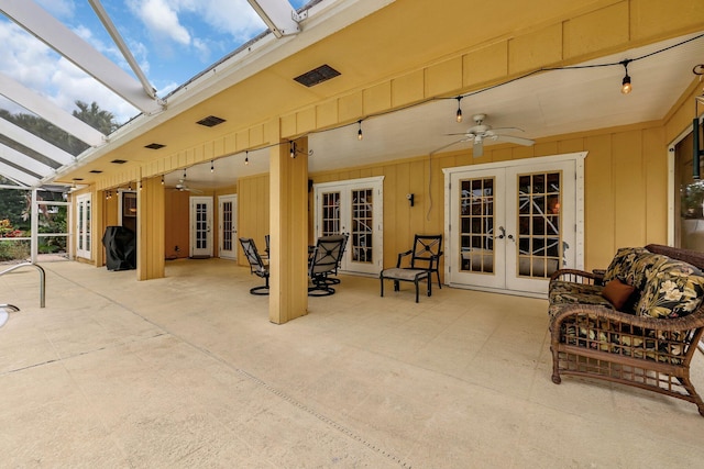 view of patio with ceiling fan, french doors, and glass enclosure