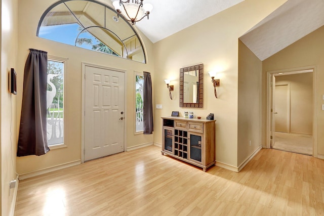 1643 SW Gregor Way, Stuart, FL 34997 - foyer entrance featuring vaulted ceiling, light wood-style flooring, and a chandelier