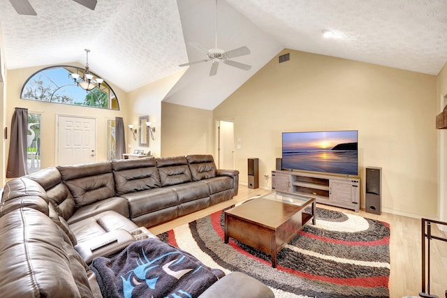 1643 SW Gregor Way, Stuart, FL 34997 - living area featuring a ceiling fan, lofted ceiling, wood finished floors, a textured ceiling, and a chandelier