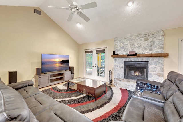 1643 SW Gregor Way, Stuart, FL 34997 - living room featuring a ceiling fan, a stone fireplace, high vaulted ceiling, and french doors