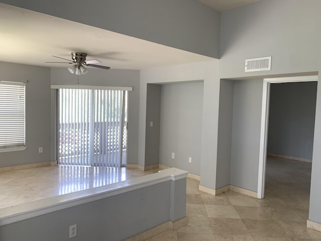 spare room with a wealth of natural light and ceiling fan