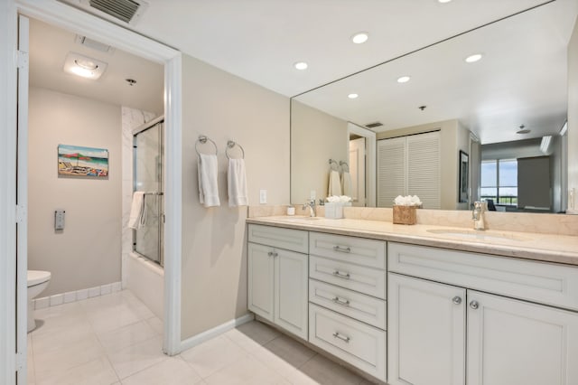 full bathroom with tile patterned flooring, combined bath / shower with glass door, toilet, and vanity