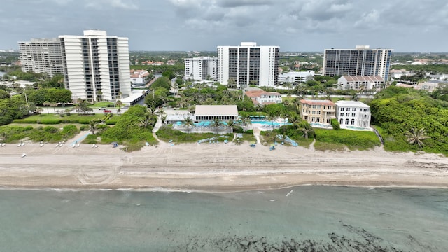 bird's eye view featuring a water view and a beach view