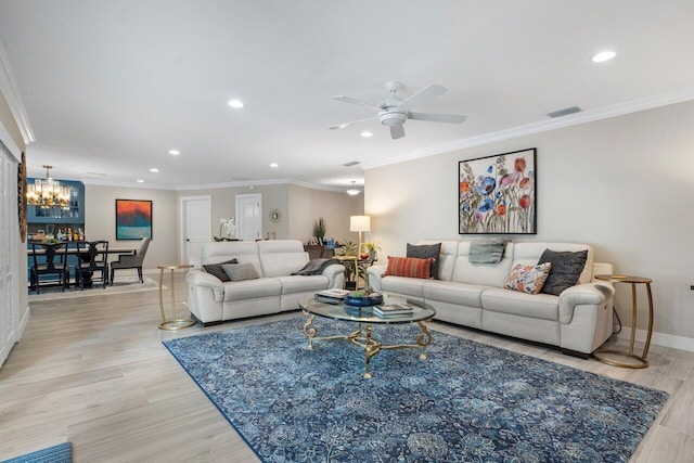 living room with ceiling fan with notable chandelier, light wood-type flooring, and crown molding