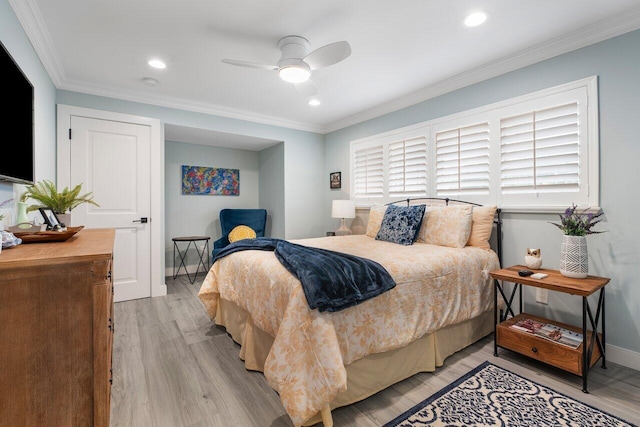 bedroom featuring ornamental molding, light wood-type flooring, and ceiling fan