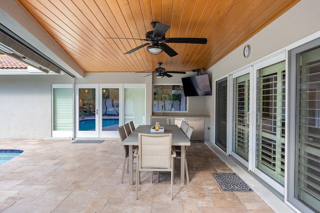 view of patio / terrace with ceiling fan, french doors, and sink