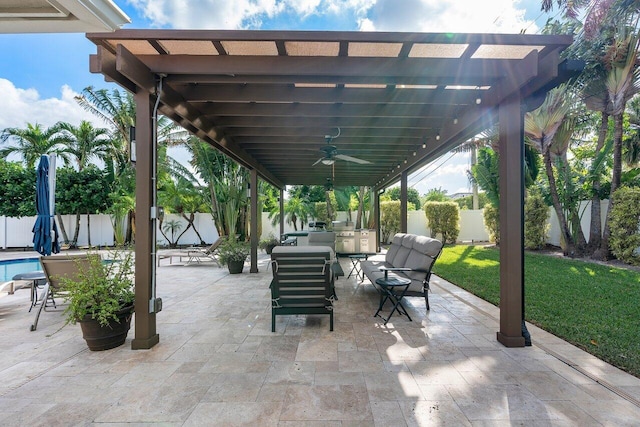 view of patio with exterior kitchen and ceiling fan