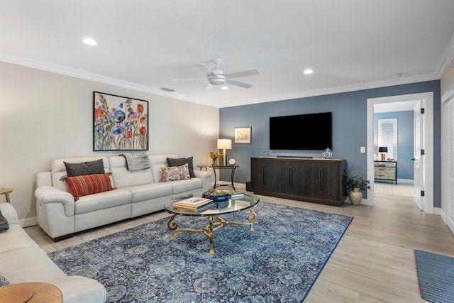 living room featuring light hardwood / wood-style floors, ceiling fan, and ornamental molding