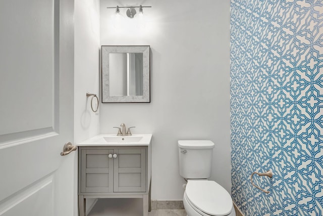 bathroom featuring vanity and toilet