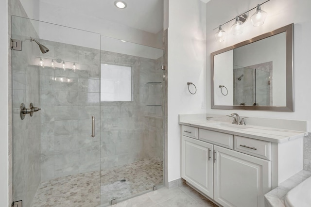 bathroom featuring tile patterned flooring, vanity, and independent shower and bath