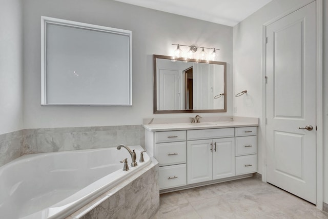 bathroom featuring vanity and a relaxing tiled tub