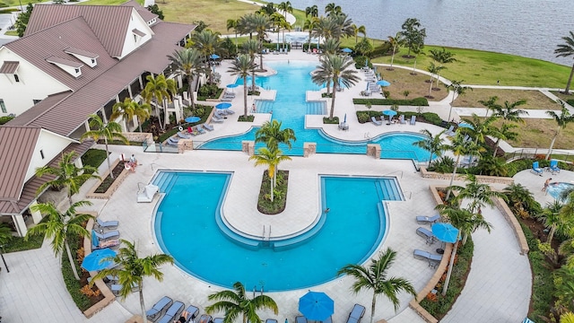 view of swimming pool featuring a water view