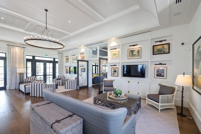 living room featuring french doors, dark hardwood / wood-style flooring, ornamental molding, an inviting chandelier, and beamed ceiling