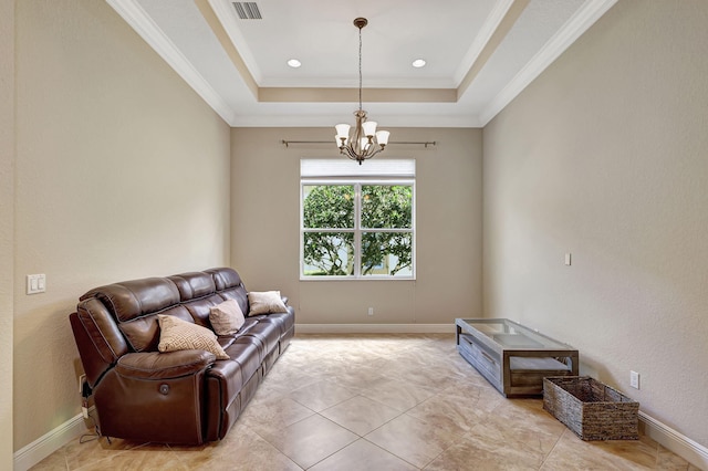 living room with a tray ceiling, a chandelier, and ornamental molding