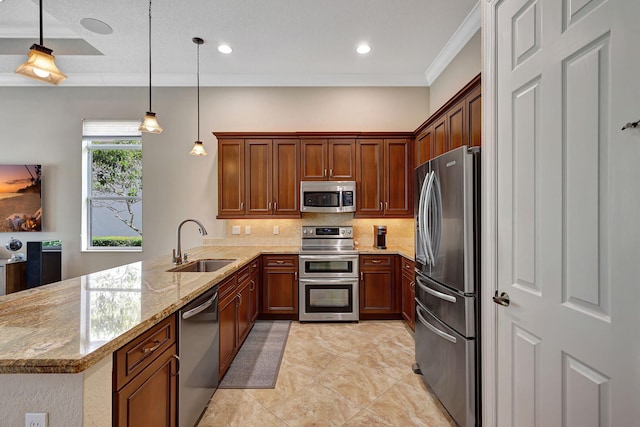 kitchen featuring pendant lighting, sink, appliances with stainless steel finishes, light stone counters, and kitchen peninsula