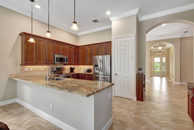 kitchen featuring sink, stainless steel appliances, tasteful backsplash, pendant lighting, and ornamental molding