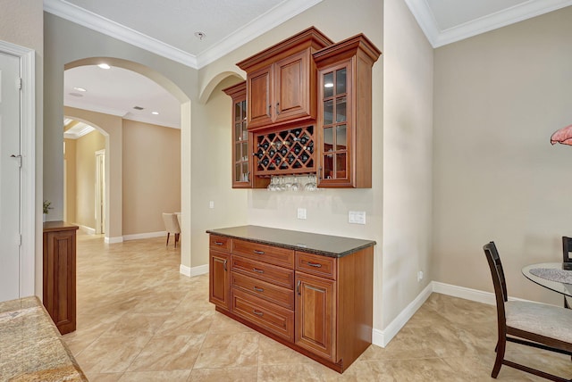 bar featuring ornamental molding and dark stone countertops