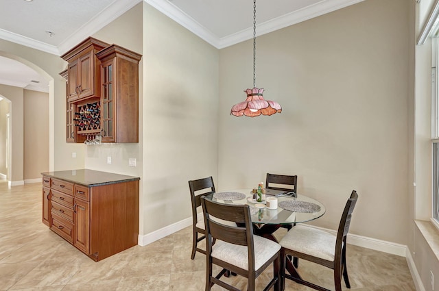 tiled dining room featuring ornamental molding