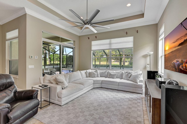 living room featuring ceiling fan, plenty of natural light, and ornamental molding