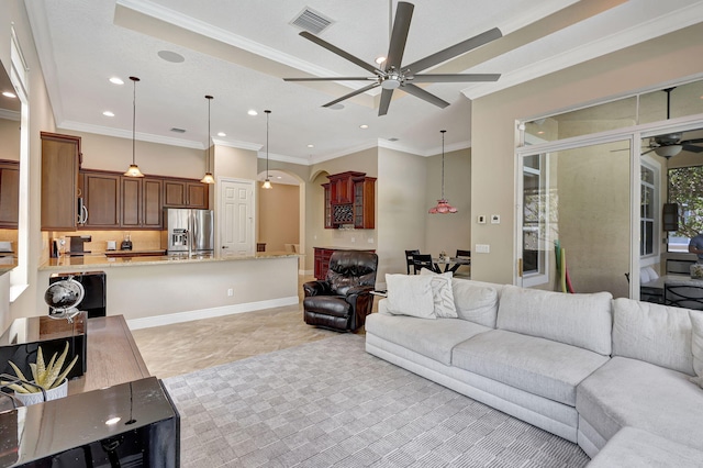 living room with crown molding, ceiling fan, and light tile patterned floors