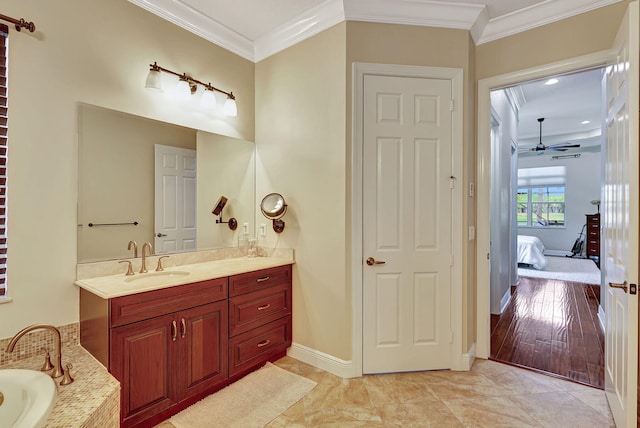 bathroom with vanity, ceiling fan, ornamental molding, and tiled bath