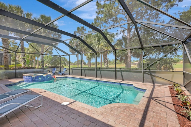 view of pool featuring an in ground hot tub, a patio, and glass enclosure