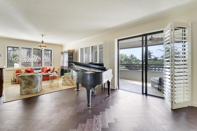 miscellaneous room featuring parquet floors, a textured ceiling, and ornamental molding