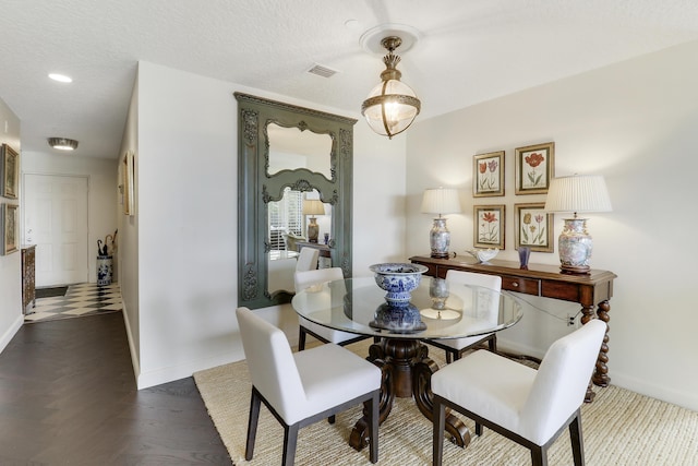 dining space with a textured ceiling