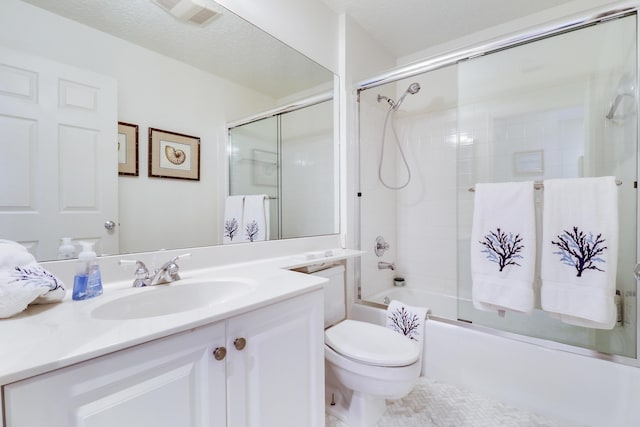 full bathroom featuring shower / bath combination with glass door, a textured ceiling, vanity, and toilet