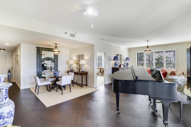 miscellaneous room with a textured ceiling, dark parquet floors, and ornamental molding