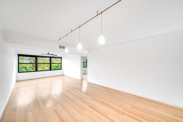 unfurnished room featuring ceiling fan, rail lighting, and wood-type flooring