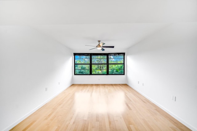 spare room with ceiling fan and light wood-type flooring