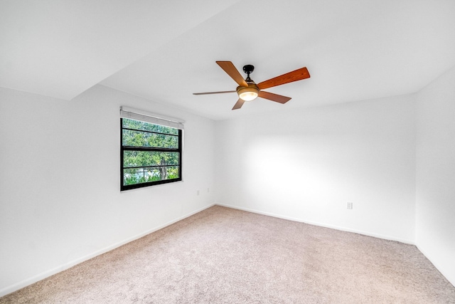 spare room featuring carpet flooring and ceiling fan