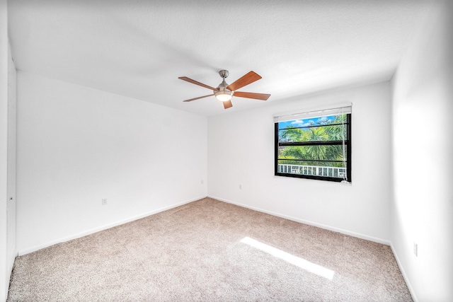 empty room with carpet flooring and ceiling fan