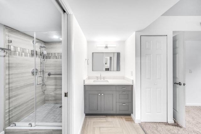 bathroom featuring vanity and a shower with door