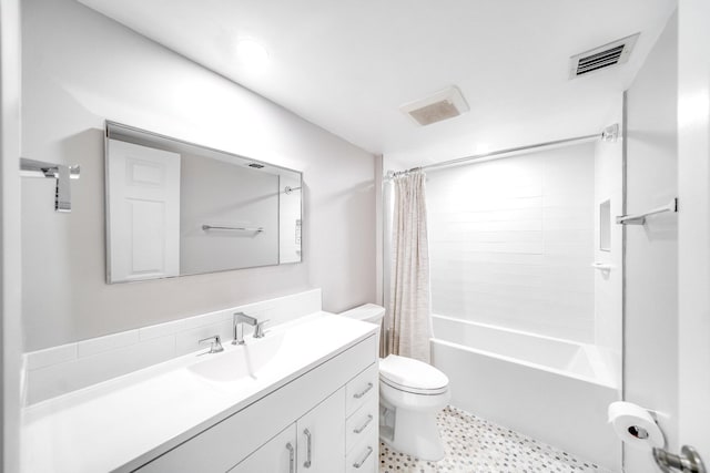 full bathroom with vanity, shower / bath combo, and toilet