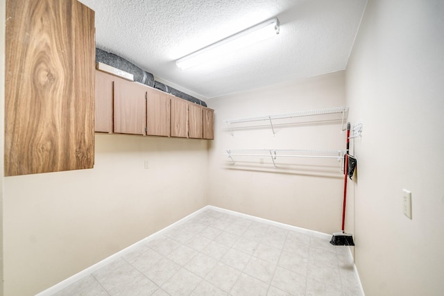 clothes washing area featuring a textured ceiling